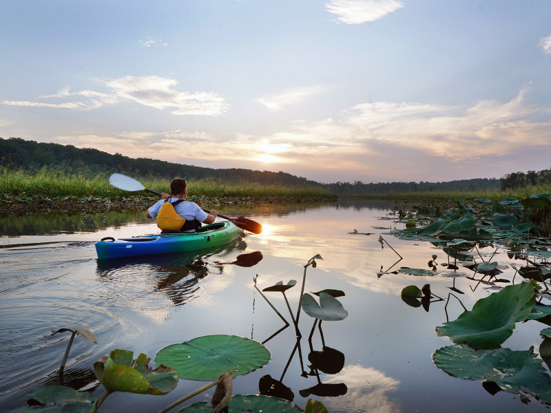 kayaker on the water at sunset