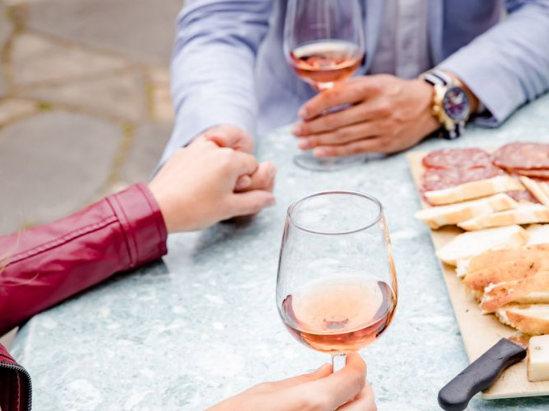 couple holding hands while drinking wine at Potomac Point Winery
