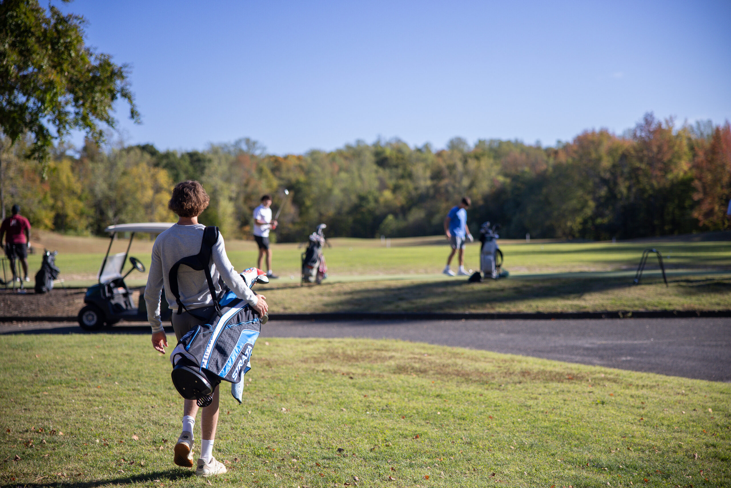 golfer walks at augustine golf